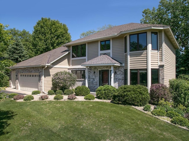 17768 Keystone Ave, Lakeville, MN 55044 - view of front of house featuring a garage, a front yard, brick siding, and roof with shingles