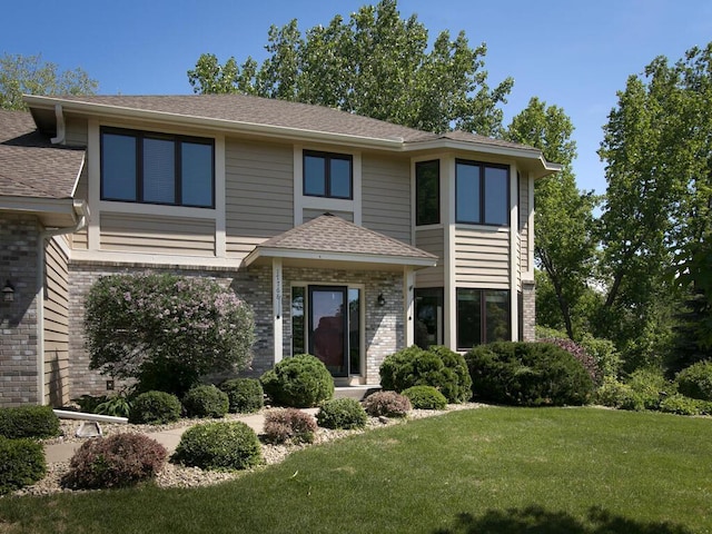 17768 Keystone Ave, Lakeville, MN 55044 - view of front facade featuring brick siding, a front yard, and roof with shingles