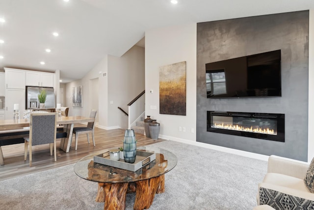 6749 168th Ln N, Ramsey, MN 55303 - living room featuring a large fireplace, stairs, recessed lighting, baseboards, and vaulted ceiling