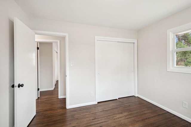 761 Labore Rd, Little Canada, MN 55117 - unfurnished bedroom featuring dark wood-type flooring, baseboards, and a closet