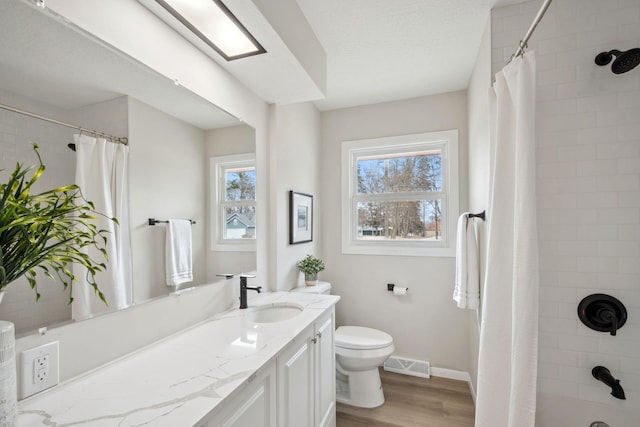 761 Labore Rd, Little Canada, MN 55117 - bathroom with wood finished floors, curtained shower, toilet, vanity, and baseboards