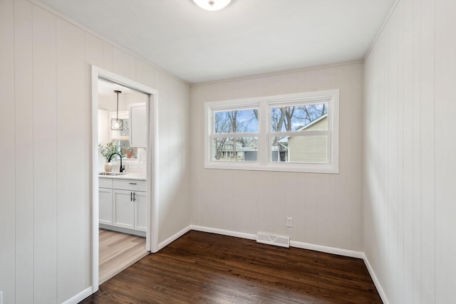 761 Labore Rd, Little Canada, MN 55117 - empty room featuring a sink, dark wood-type flooring, baseboards, and crown molding