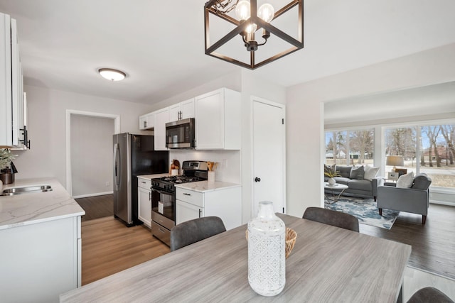 761 Labore Rd, Little Canada, MN 55117 - dining room featuring a chandelier and light wood finished floors