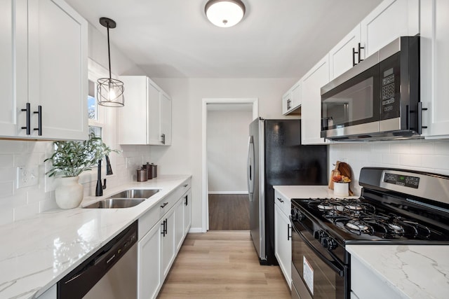761 Labore Rd, Little Canada, MN 55117 - kitchen featuring appliances with stainless steel finishes, a sink, baseboards, light wood-type flooring, and white cabinets