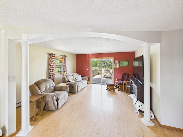 31528 63rd St, Royalton, MN 56373 - living room with wood finished floors, a textured ceiling, decorative columns, and a baseboard radiator