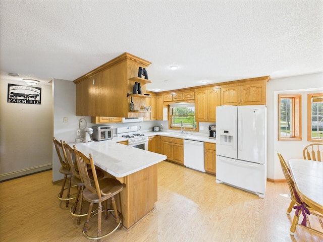 31528 63rd St, Royalton, MN 56373 - kitchen featuring white appliances, open shelves, a peninsula, light countertops, and light wood-type flooring