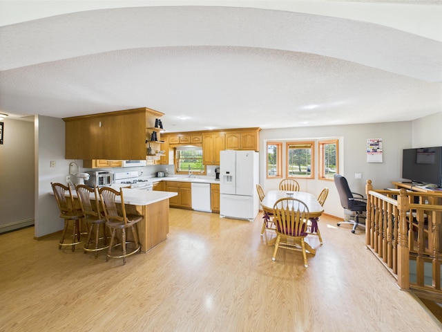 31528 63rd St, Royalton, MN 56373 - kitchen featuring white appliances, light countertops, a peninsula, open shelves, and light wood-style flooring