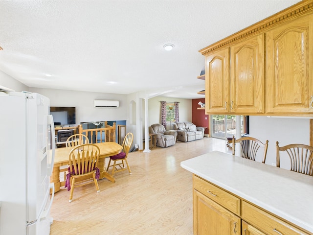 31528 63rd St, Royalton, MN 56373 - kitchen with white refrigerator with ice dispenser, a wall unit AC, light wood finished floors, open floor plan, and light countertops