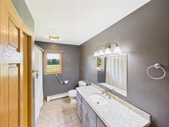 31528 63rd St, Royalton, MN 56373 - bathroom with a baseboard heating unit, toilet, stone finish flooring, baseboards, and vanity