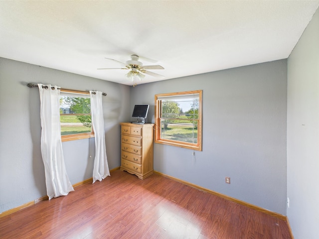 31528 63rd St, Royalton, MN 56373 - empty room featuring healthy amount of natural light, ceiling fan, light wood finished floors, and baseboards