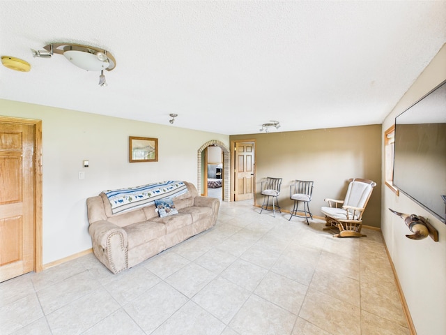 31528 63rd St, Royalton, MN 56373 - living room featuring light tile patterned flooring, baseboards, and arched walkways