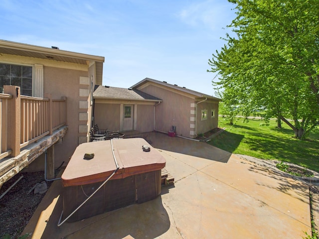 31528 63rd St, Royalton, MN 56373 - rear view of property featuring a hot tub, a patio, a yard, and stucco siding