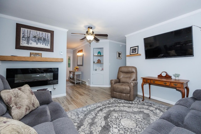 30202 Shady Ln, Detroit Lakes, MN 56501 - living area featuring crown molding, wood finished floors, built in shelves, a ceiling fan, and baseboards
