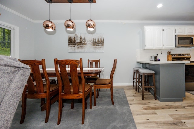 30202 Shady Ln, Detroit Lakes, MN 56501 - dining space featuring crown molding, light wood-style flooring, recessed lighting, and baseboards