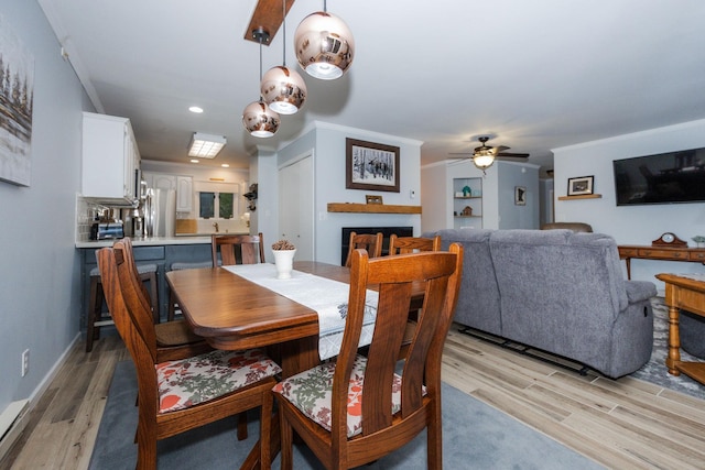 30202 Shady Ln, Detroit Lakes, MN 56501 - dining space featuring light wood-style flooring, a ceiling fan, a fireplace, and recessed lighting