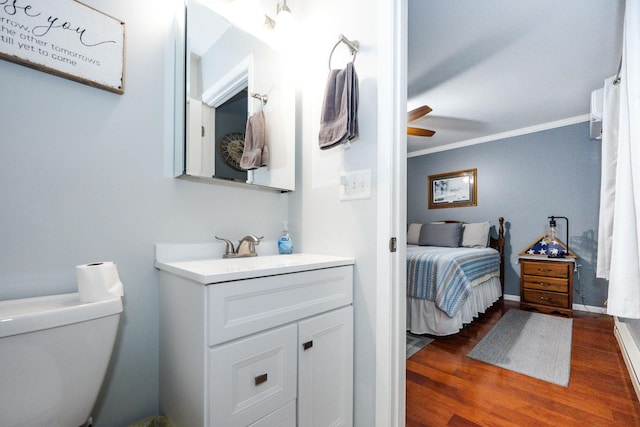 30202 Shady Ln, Detroit Lakes, MN 56501 - bathroom with wood finished floors, vanity, ceiling fan, toilet, and crown molding
