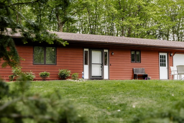 30202 Shady Ln, Detroit Lakes, MN 56501 - view of front facade with a garage, a front lawn, and roof with shingles