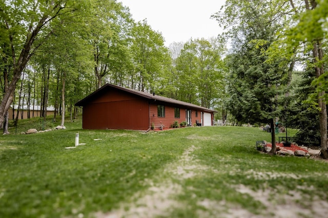 30202 Shady Ln, Detroit Lakes, MN 56501 - view of side of home featuring an attached garage and a yard
