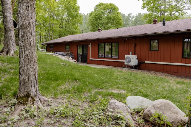 30202 Shady Ln, Detroit Lakes, MN 56501 - rear view of property with a shingled roof, a lawn, and a cooling unit