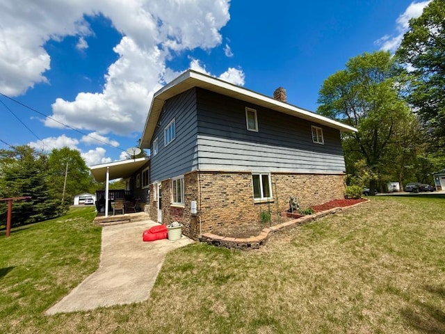 725 8th St NE, Staples, MN 56479 - view of home's exterior with a chimney, a yard, and a patio
