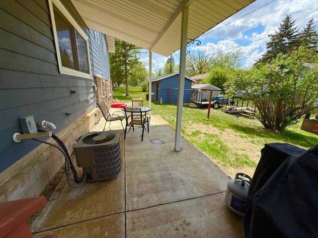 725 8th St NE, Staples, MN 56479 - view of patio / terrace featuring central AC, an outdoor structure, and a storage unit