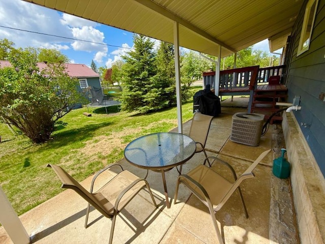 725 8th St NE, Staples, MN 56479 - view of patio / terrace featuring a trampoline, cooling unit, and outdoor dining space