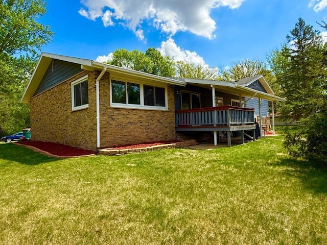 725 8th St NE, Staples, MN 56479 - rear view of property with a deck, a lawn, and brick siding