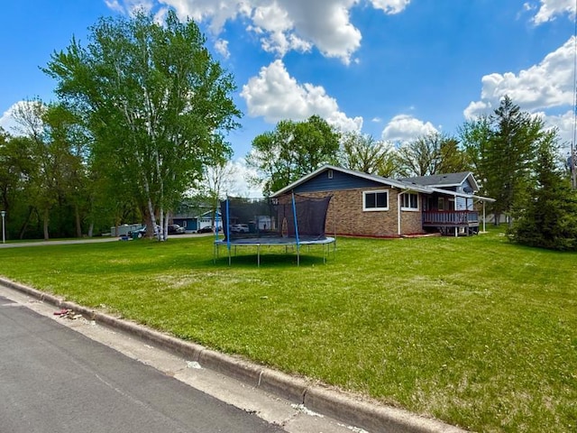 725 8th St NE, Staples, MN 56479 - view of green lawn featuring a trampoline