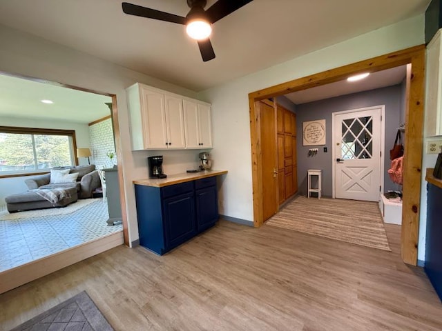 725 8th St NE, Staples, MN 56479 - kitchen featuring white cabinets, blue cabinetry, light wood-style flooring, ceiling fan, and recessed lighting