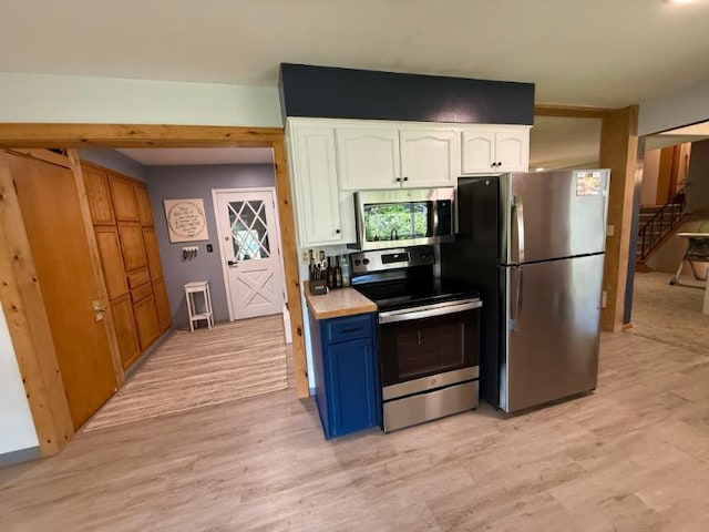 725 8th St NE, Staples, MN 56479 - kitchen with stainless steel appliances, white cabinets, light wood finished floors, and light countertops