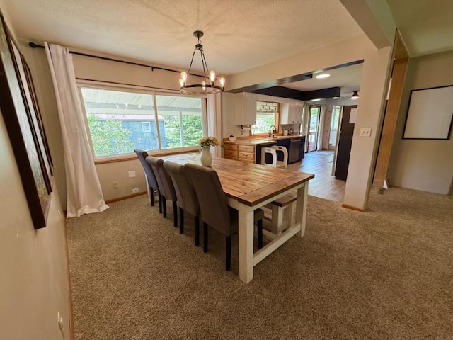 725 8th St NE, Staples, MN 56479 - dining room with a chandelier, light carpet, baseboards, and a textured ceiling