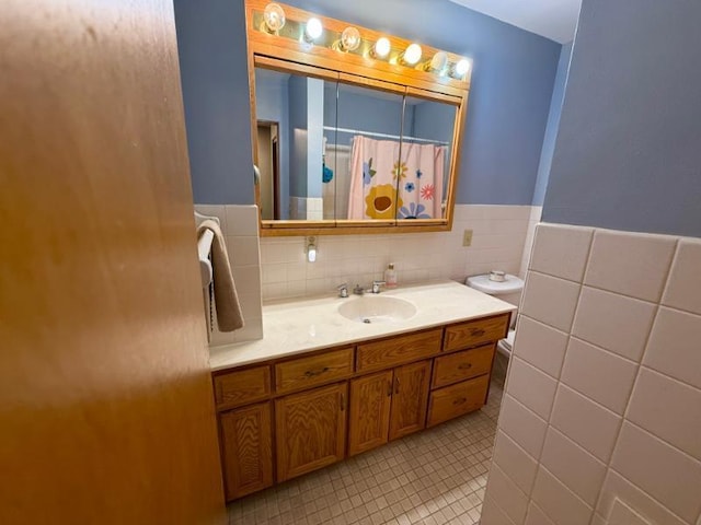 725 8th St NE, Staples, MN 56479 - bathroom featuring tile walls, tile patterned flooring, vanity, a wainscoted wall, and curtained shower