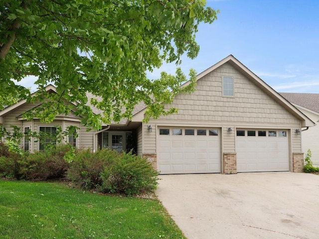 1232 Cypress Dr W, Annandale, MN 55302 - view of front of property with driveway, an attached garage, brick siding, and a front yard