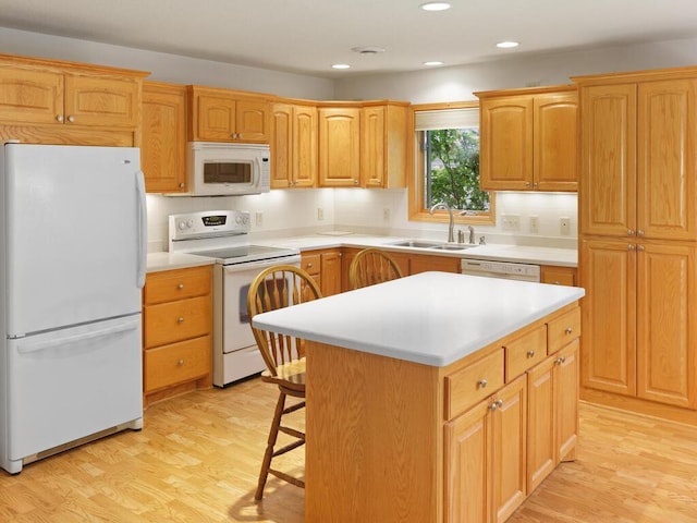 1232 Cypress Dr W, Annandale, MN 55302 - kitchen featuring white appliances, a sink, light wood-style flooring, a kitchen island, and light countertops