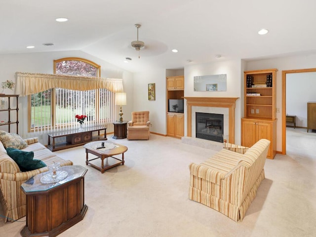 1232 Cypress Dr W, Annandale, MN 55302 - living area with light colored carpet, a glass covered fireplace, lofted ceiling, ceiling fan, and recessed lighting