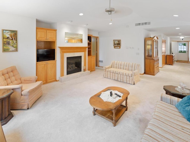 1232 Cypress Dr W, Annandale, MN 55302 - living room with light colored carpet, a glass covered fireplace, recessed lighting, lofted ceiling, and ceiling fan