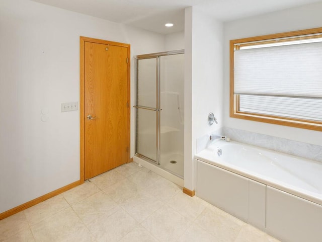 1232 Cypress Dr W, Annandale, MN 55302 - bathroom featuring a stall shower, a garden tub, and baseboards