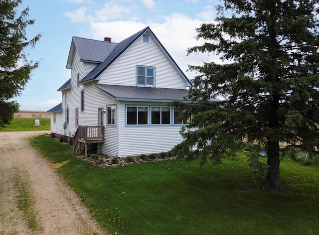 N4190 County Road P, Weston Twp, WI 54767 - view of side of home featuring metal roof, a yard, dirt driveway, and a chimney