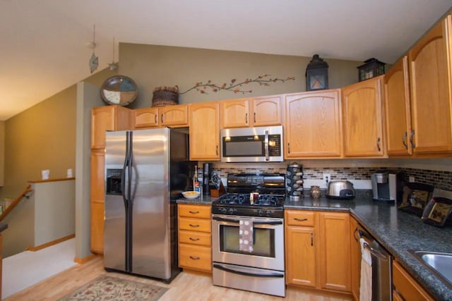 124 Waynesborough Way, Mankato, MN 56001 - kitchen with appliances with stainless steel finishes, lofted ceiling, light wood-type flooring, backsplash, and a sink
