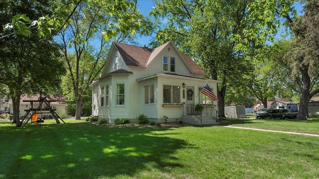 1104 Elm St, Alexandria, MN 56308 - view of front of house with a playground and a front lawn