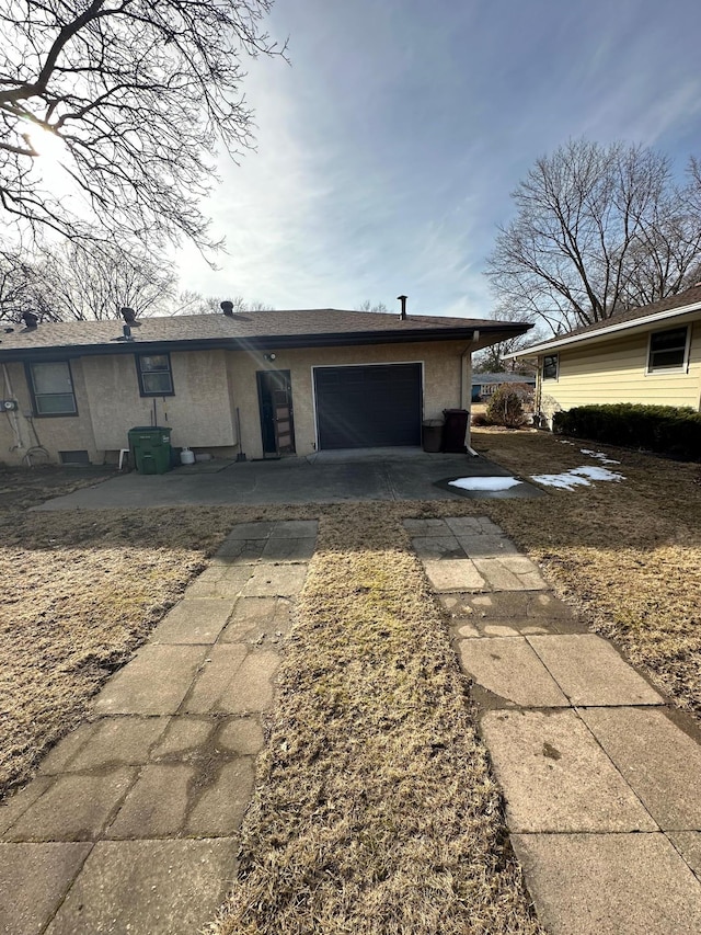 2814 Matilda St, Roseville, MN 55113 - view of front of home featuring an attached garage, driveway, and stucco siding
