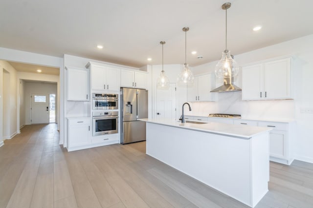 11454 Fieldstone Dr, Rogers, MN 55311 - kitchen with stainless steel appliances, a sink, wall chimney range hood, white cabinets, and light countertops