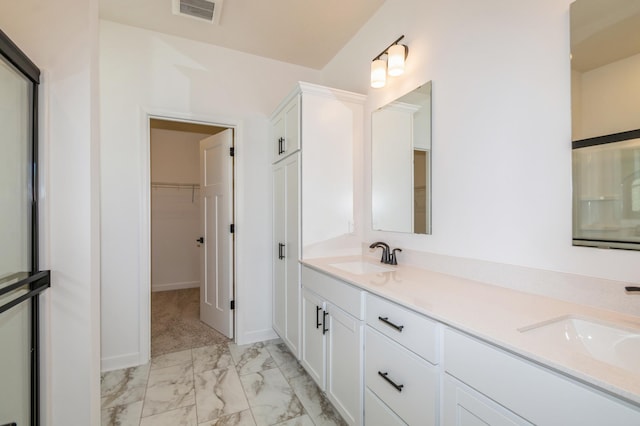 11454 Fieldstone Dr, Rogers, MN 55311 - bathroom featuring marble finish flooring, a walk in closet, double vanity, and baseboards