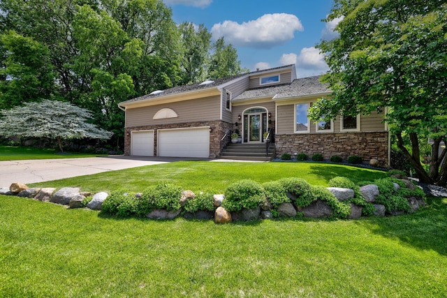 9378 Olympia Dr, Eden Prairie, MN 55347 - view of front of house with stone siding, a front lawn, concrete driveway, and an attached garage