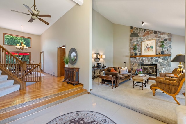 9378 Olympia Dr, Eden Prairie, MN 55347 - living area with high vaulted ceiling, a chandelier, tile patterned floors, stairs, and a fireplace