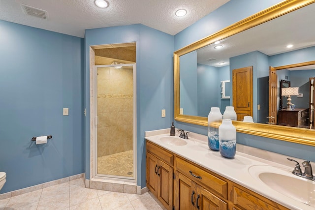 9378 Olympia Dr, Eden Prairie, MN 55347 - bathroom with a shower stall, double vanity, tile patterned floors, and a textured ceiling
