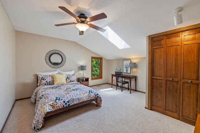 9378 Olympia Dr, Eden Prairie, MN 55347 - bedroom featuring a skylight, light colored carpet, lofted ceiling, and a ceiling fan