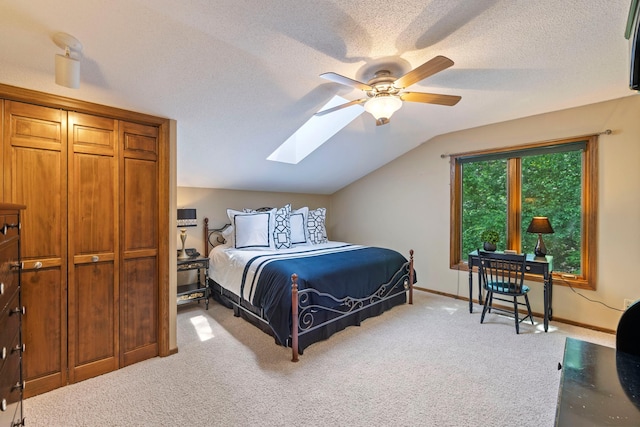 9378 Olympia Dr, Eden Prairie, MN 55347 - carpeted bedroom with a skylight, vaulted ceiling, a textured ceiling, and ceiling fan