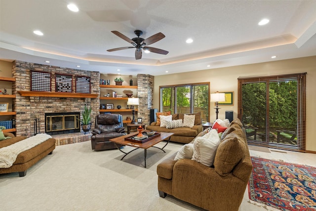 9378 Olympia Dr, Eden Prairie, MN 55347 - living area with a tray ceiling, recessed lighting, ceiling fan, and a brick fireplace