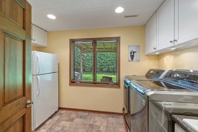 9378 Olympia Dr, Eden Prairie, MN 55347 - washroom featuring cabinet space, washing machine and clothes dryer, stone finish floors, and recessed lighting